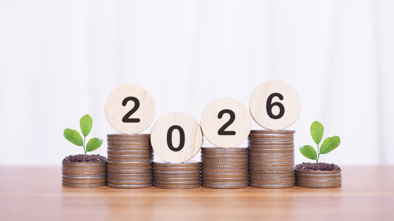 Wooden blocks with the number 2026 and plants growing up on stack of coins. The concept of saving money, Financial, Investment and Business growing in year 2026.